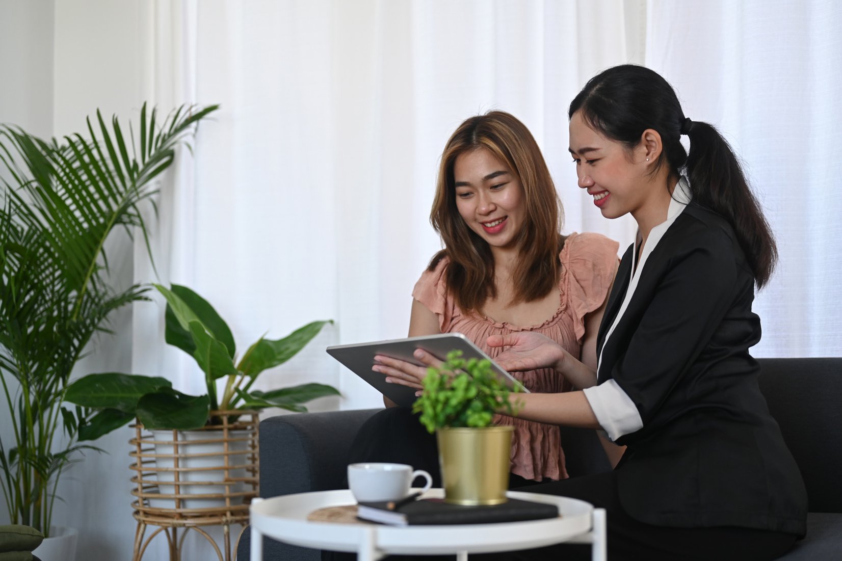 Smiling Asian Female Insurance Agent Offering Life Insurance to